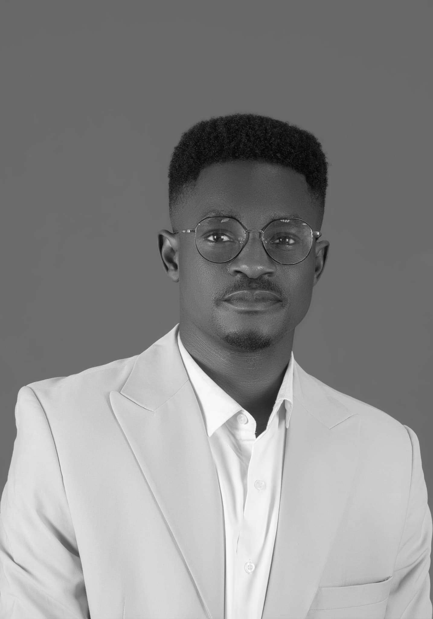Tosin Joseph Amupitan in a black-and-white studio portrait